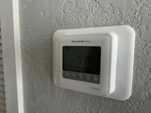 Wall-mounted indoor thermostat installed by Attee AC Services
